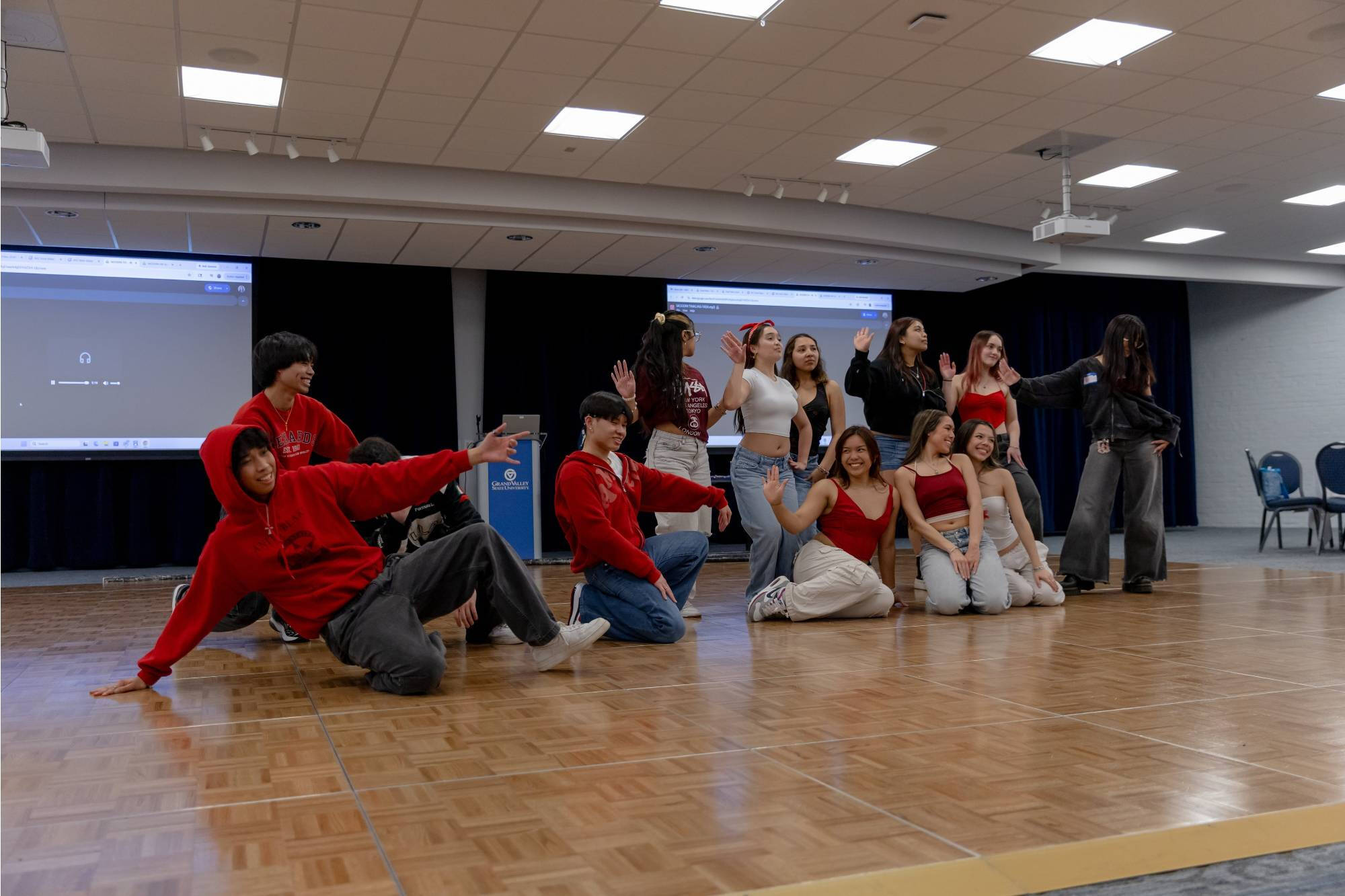 asian graduates posing at the end of a dance routine.